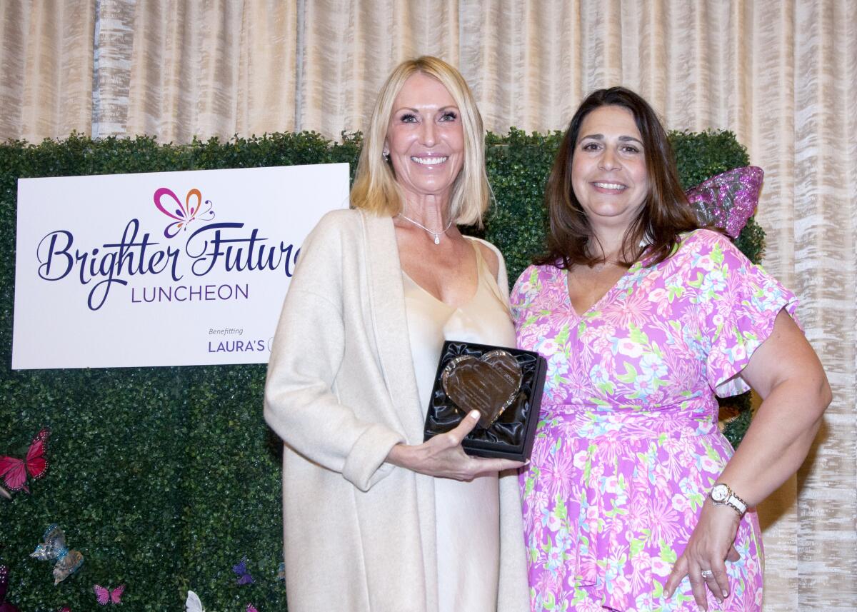 Laura's House honoree Annette Oltmans with Patty Bucklen, event chair at luncheon benefiting victims of domestic abuse.