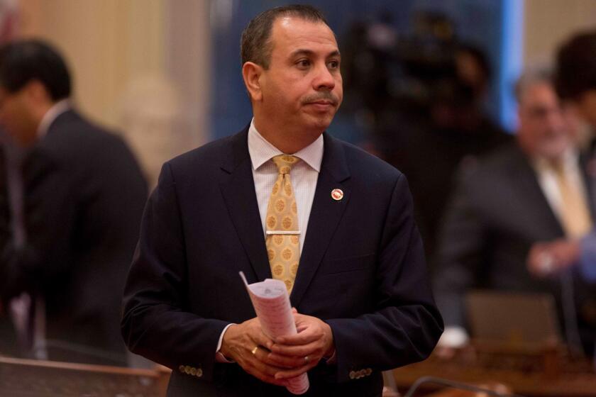 Democratic State Sen. Tony Mendoza stands on the floor of the Senate chambers in between private meetings of the Democratic caucus, Wednesday, Jan. 3, 2018, in Sacramento, Calif. Mendoza's colleagues debated whether to suspend him amid a sexual misconduct investigation during the opening day of the Senate. (AP Photo/Steve Yeater)