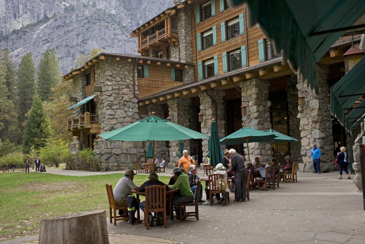 People dine outside the former Ahwahnee Hotel in Yosemite National Park.