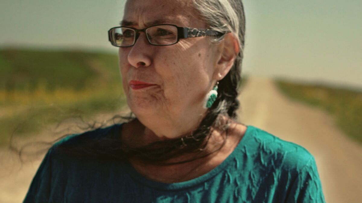 Sandy White Hawk, who is featured in the documentary "Blood Memory," walks the "road of her past" in Rosebud, S.D.