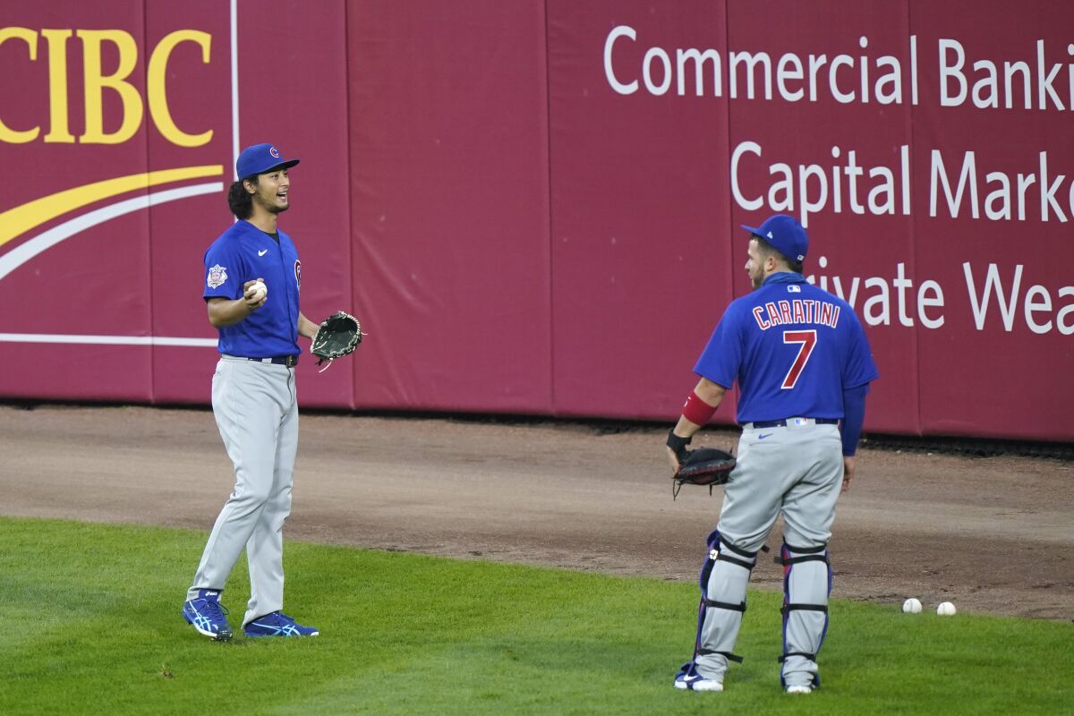 Chicago Cubs starting pitcher Yu Darvich, left, of Japan, talks with catcher Victor Caratini