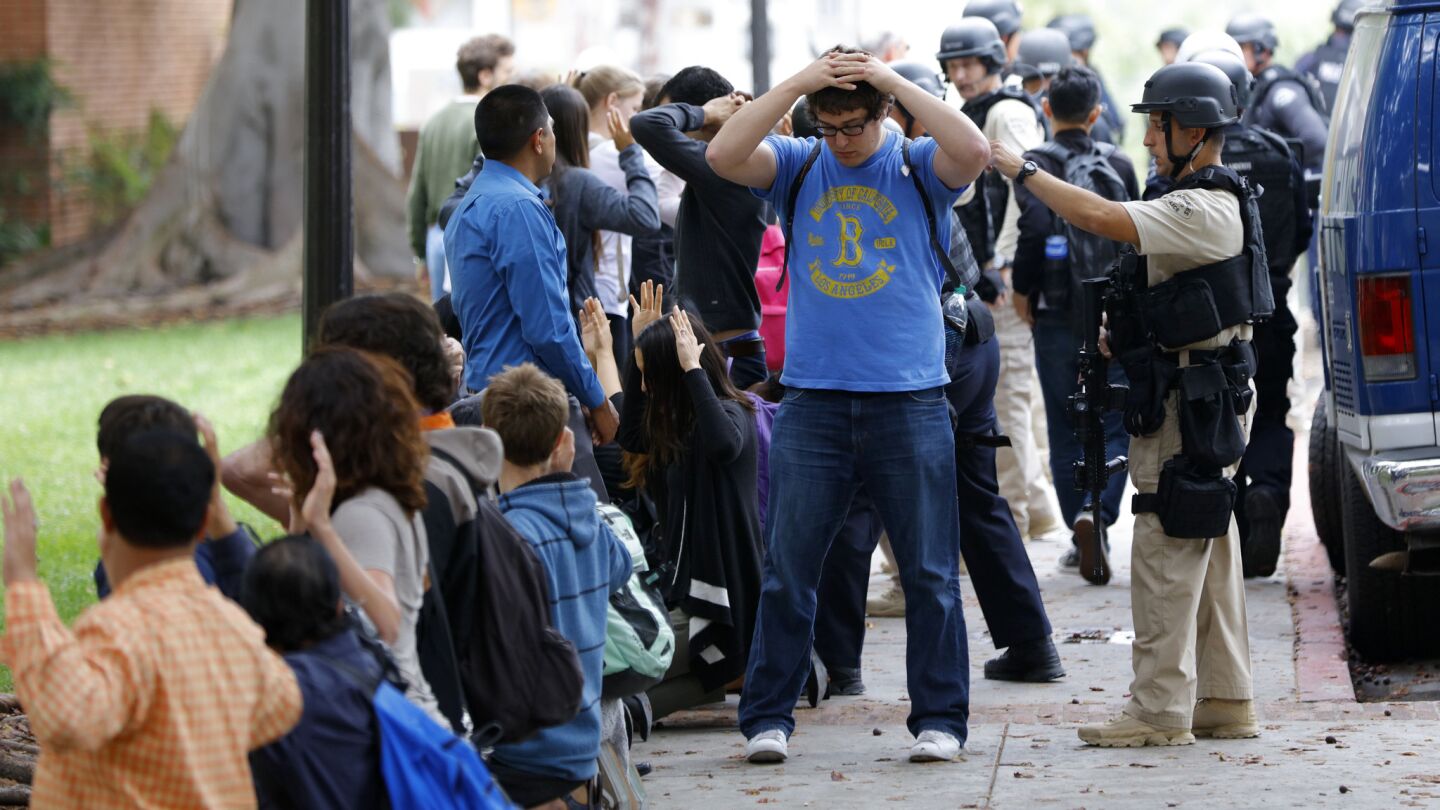 Police officers check and evacuate students after a shooting on the UCLA campus on Wednesday.