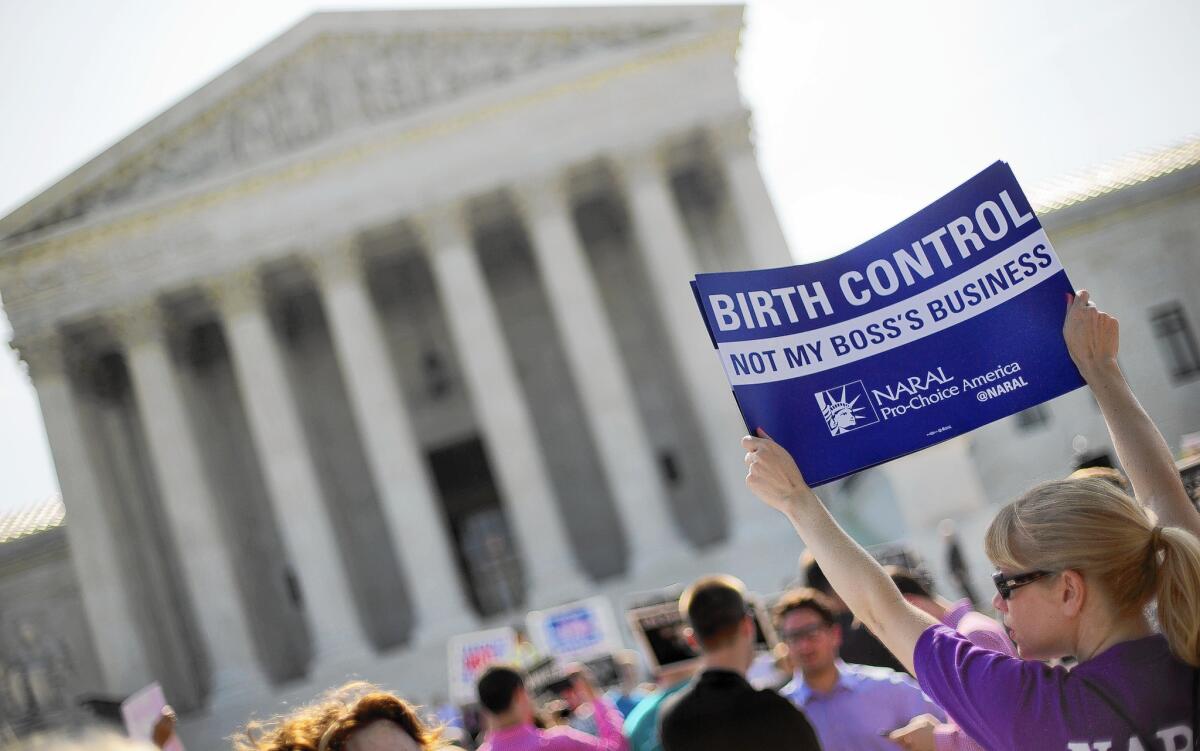 A woman protests the Supreme Court's ruling in the Hobby Lobby birth-control case in June.