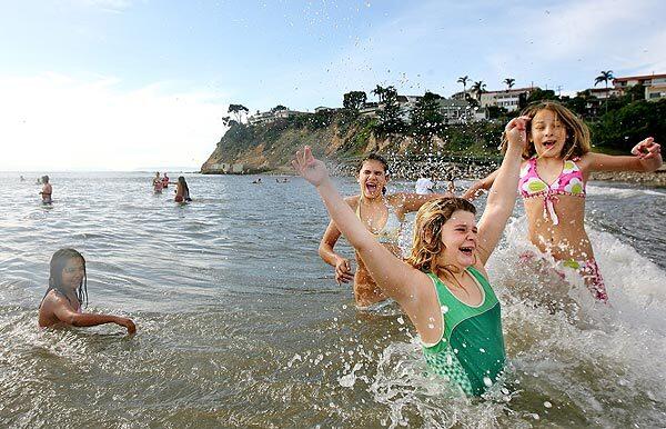Mia Leccese, 9, Krista Canetti, 11, Carly Havenick, 9, and Vianne Kelly, 12, from left, participate in the annual First Swim or Dip of the Year in San Pedro. The event is presented by the Cabrillo Beach Polar Bears.