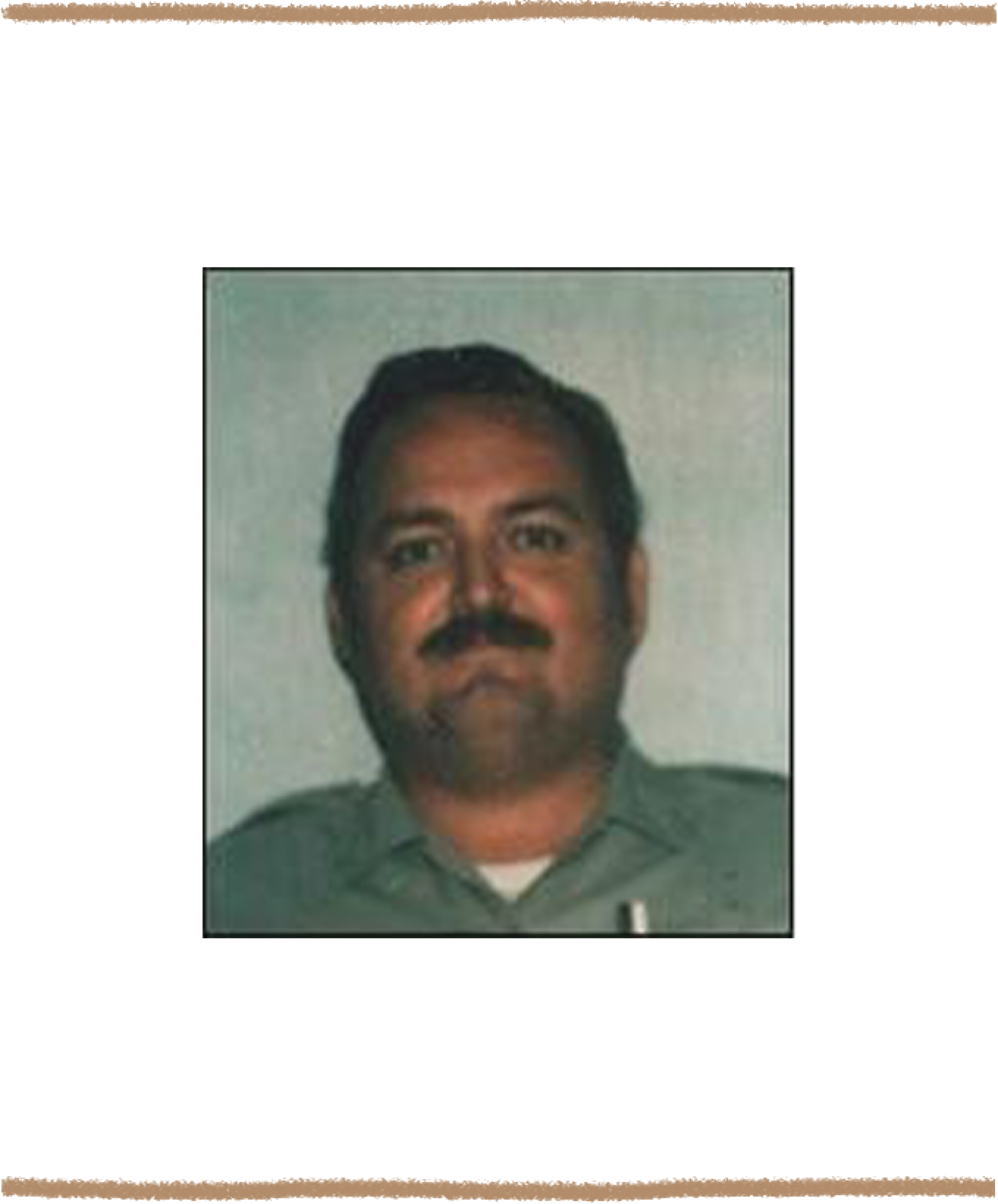 Image of a man with short dark hair and a full mustache, wearing a collared prison guard uniform