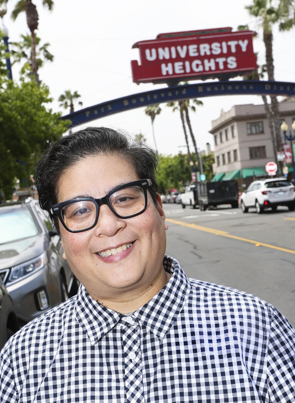 Joyce Gabiola, who is the head archivist of the Lambda Archives, poses for photos along Park Avenue in University Heights.