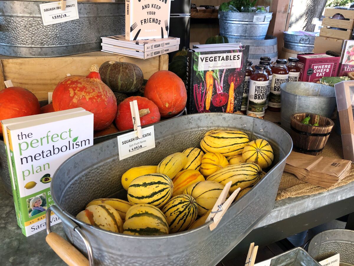A selection of fresh produce, books and bottled potassium broth at the newly opened Golden Door Country Store in San Marcos.