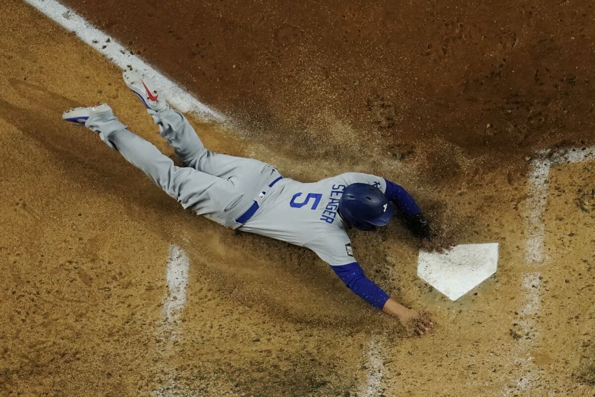 Dodgers shortstop Corey Seager scores past Tampa Bay Rays catcher Mike Zunino during the fifth inning of Game 4.
