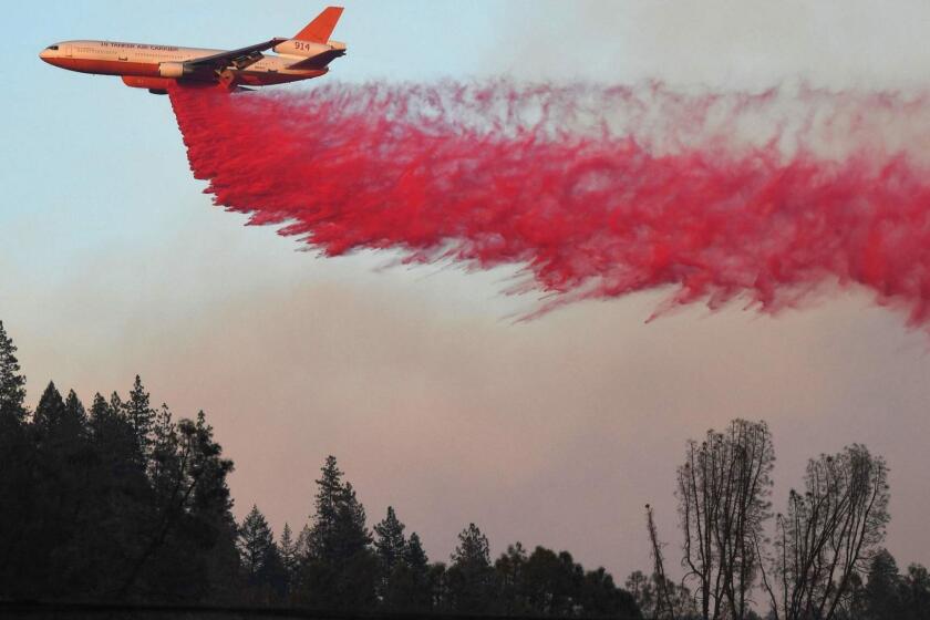 TOPSHOT - An air tanker drops fire retardent to try to contain flames from the Carr fire as it spreads towards the town of Lewiston near Redding, California, on August 2, 2018. Thousands of firefighters were struggling on August 2 to contain two vast wildfires in California, one of which has become one of the most destructive blazes in the state's history. The Carr Fire has scorched 126,00 acres (51,00 hectares) of land since July 23, when authorities say it was triggered by the "mechanical failure of a vehicle" that caused sparks to fly in tinderbox dry conditions. / AFP PHOTO / Mark RALSTONMARK RALSTON/AFP/Getty Images ** OUTS - ELSENT, FPG, CM - OUTS * NM, PH, VA if sourced by CT, LA or MoD **