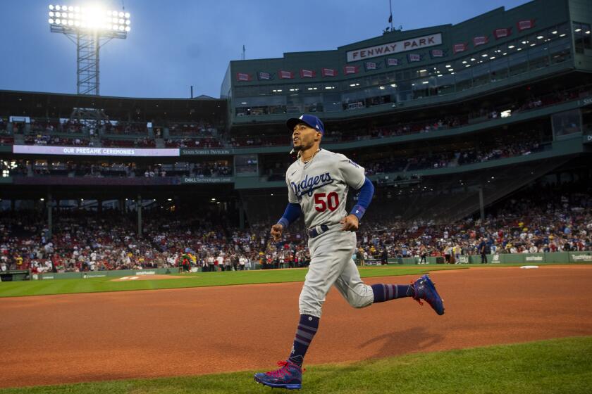 BOSTON, MA - AUGUST 25: Mookie Betts #50 of the Los Angeles Dodgers warms up.