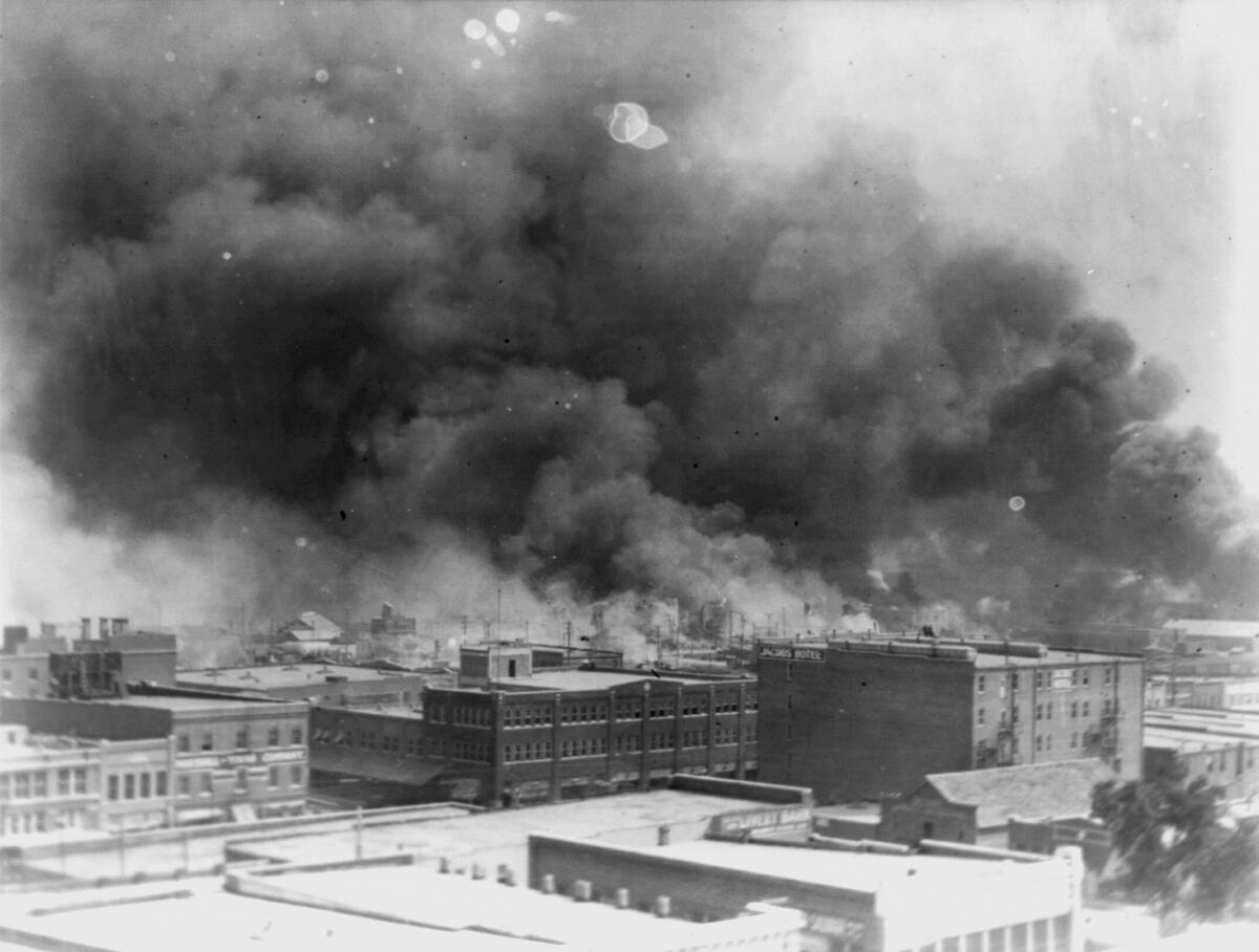A historic photo shows smoke billowing over Tulsa, Okla.
