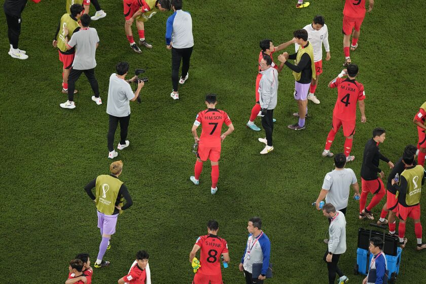 South Korea's Son Heung-min, center, reacts to the team's 4-1 loss after the World Cup round of 16 soccer match between Brazil and South Korea, at the Stadium 974 in Doha, Qatar, Monday, Dec. 5, 2022. (AP Photo/Pavel Golovkin)