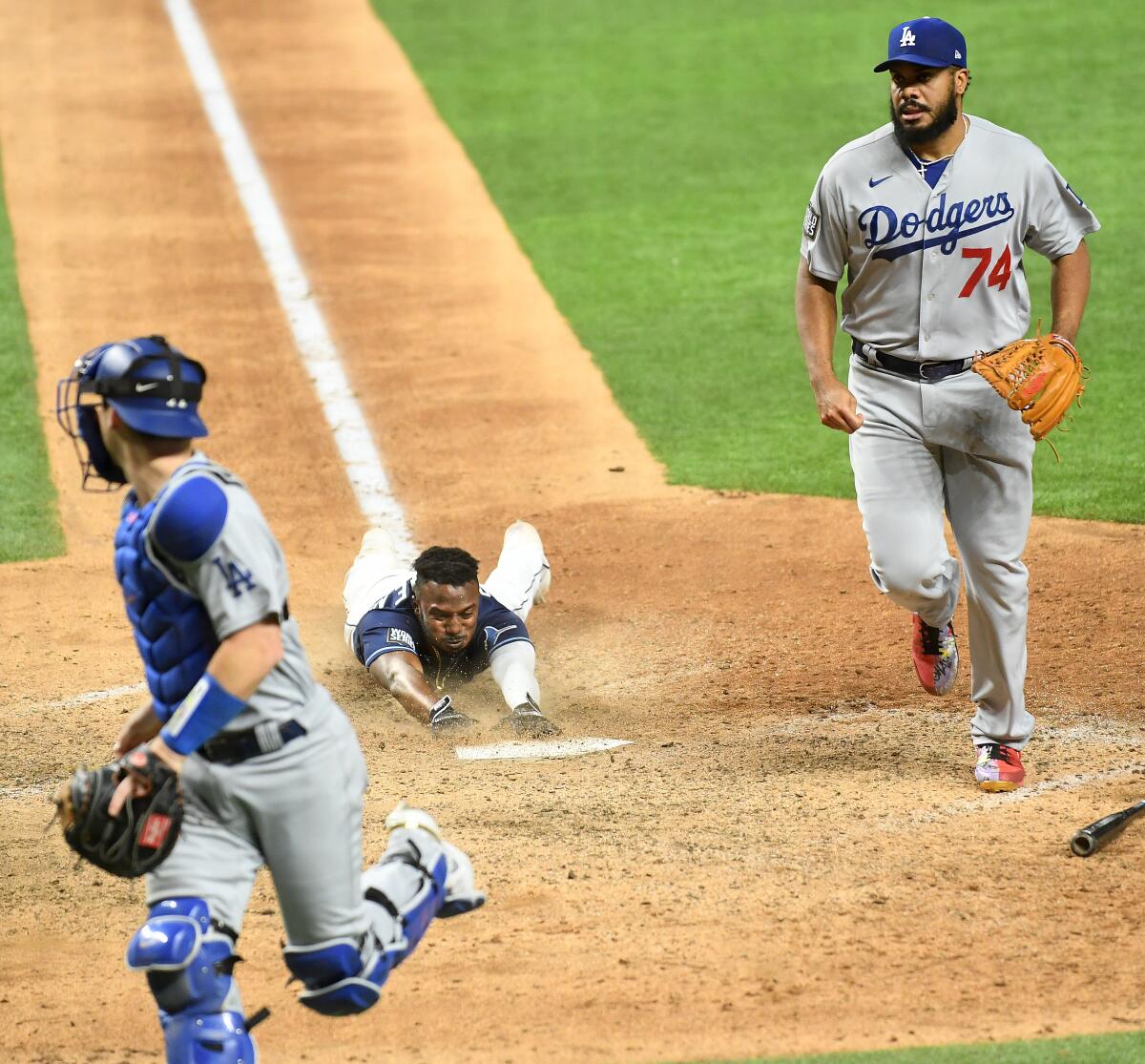 Tampa Bay baserunner Randy Arozarena scores the winning run in front of Dodgers pitcher Kenley Jansen.