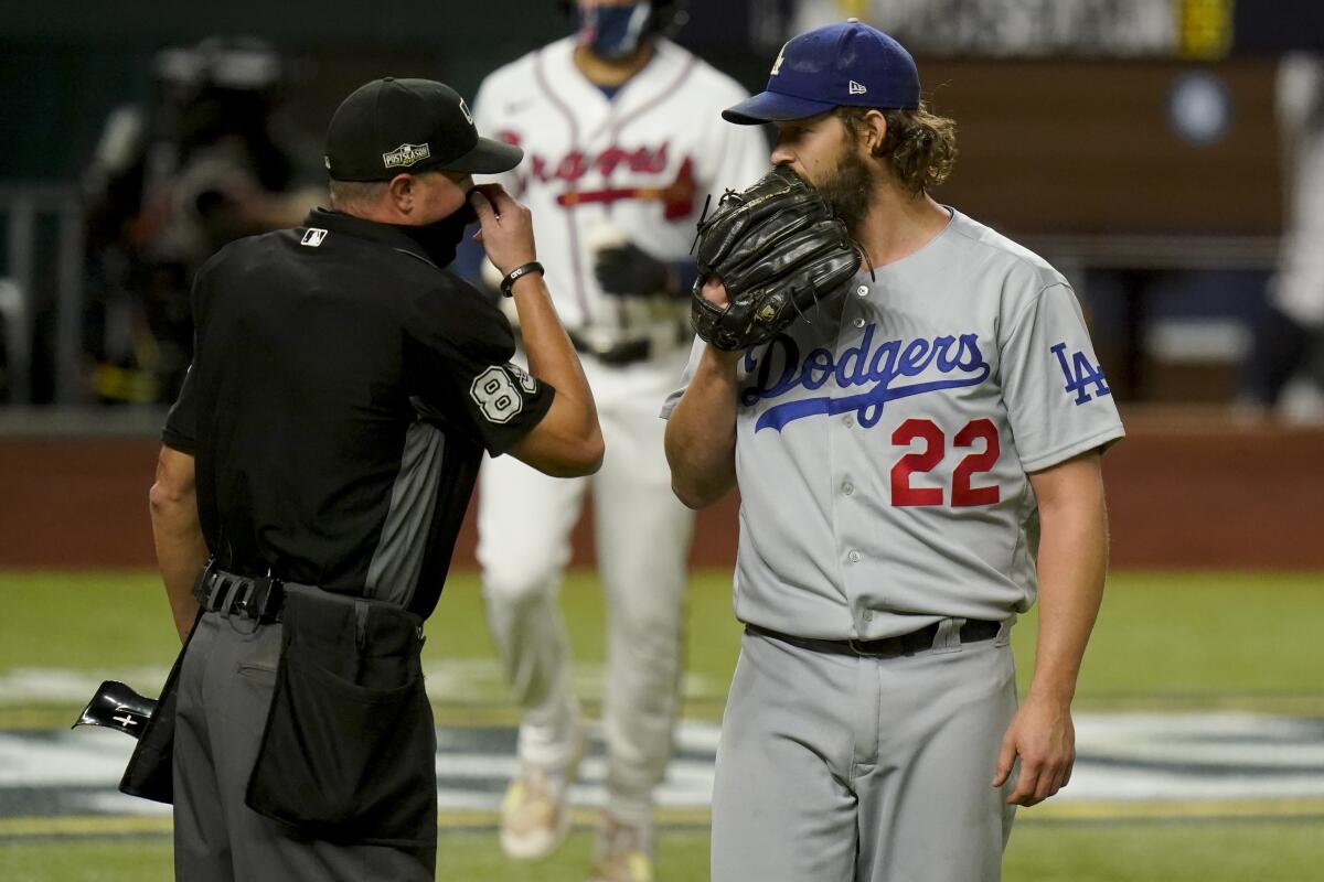Dodgers starter Clayton Kershaw speaks with home plate umpire Cory Blaser during the first inning of Game 4 of the NLCS.