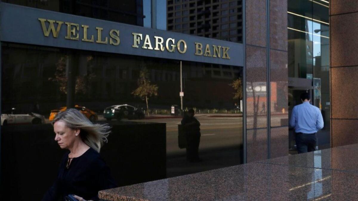 A pedestrian walks past Wells Fargo's downtown Los Angeles offices.