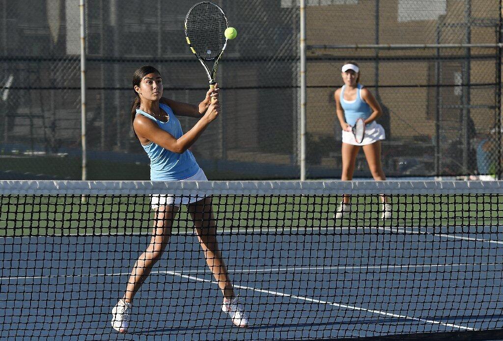 Corona del Mar's Camellia Edalat returns a shot during a doubles match against University with her partner Brooke Kenerson on Tuesday.