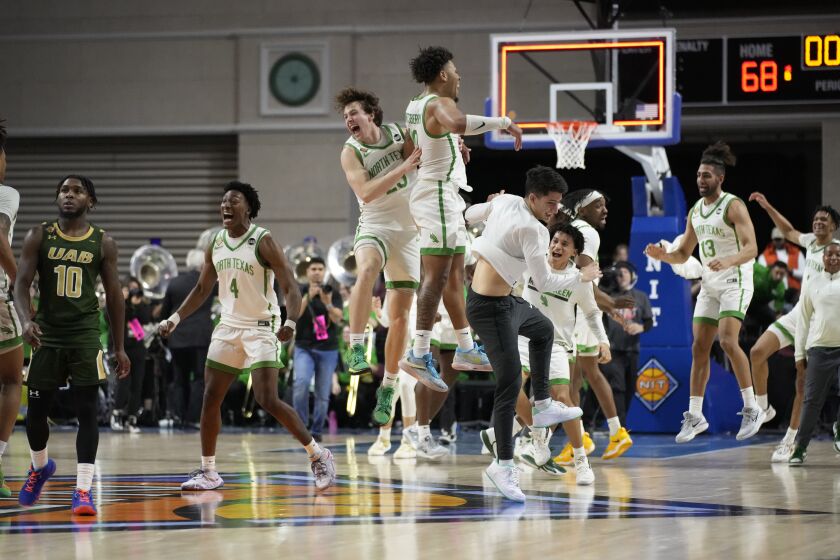 North Texas players celebrate after defeating UAB in an NCAA college basketball game in the final of the NIT, Thursday, March 30, 2023, in Las Vegas. (AP Photo/John Locher)