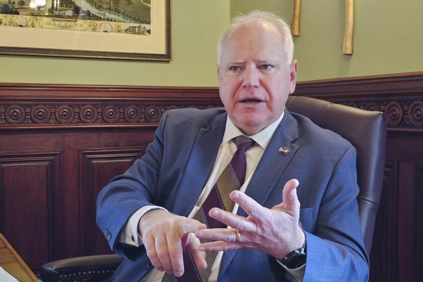 FILE - Minnesota Gov. Tim Walz discusses the upcoming 2024 legislative session during an interview at his office in the state Capitol, Feb. 7, 2024. (AP Photo/Steve Karnowski, File)