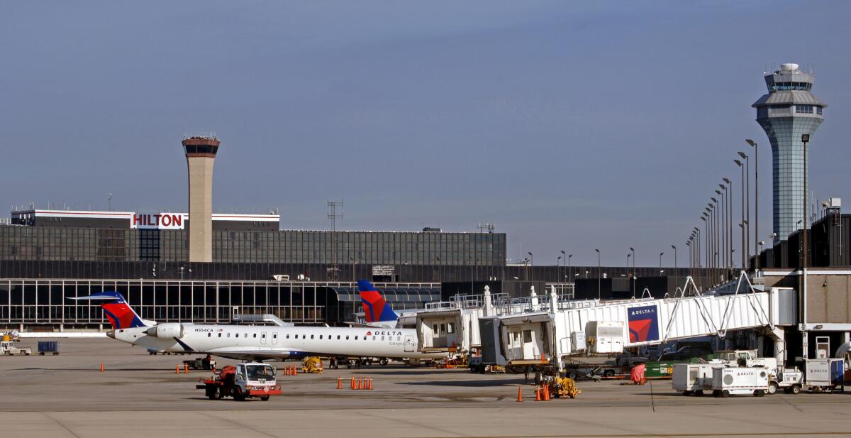A file photo shows two control towers at O'Hare International Airport. Smoke at an FAA facility in a nearby town prompted a halt of all traffic in and out of the airport on Tuesday.