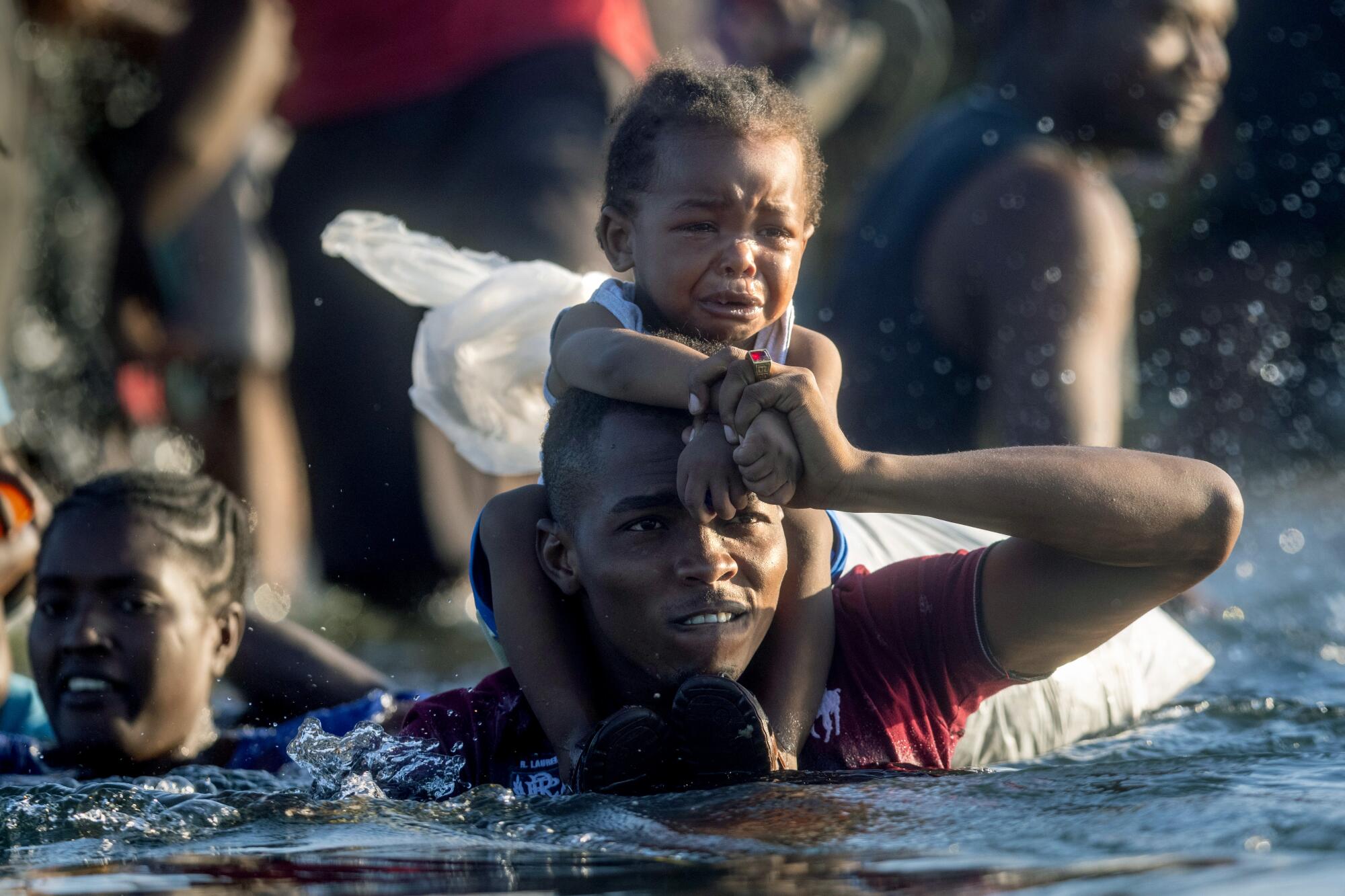 Haitian immigrants cross the Rio Grande back into Mexico from Del Rio, Texas on September 20, 2021.