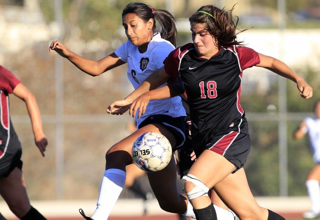 Vanguard's Kayla Arenas, left, battles Westmont's Sophie Fuller for the ball during the first half at Biola University in La Mirada on Tuesday.