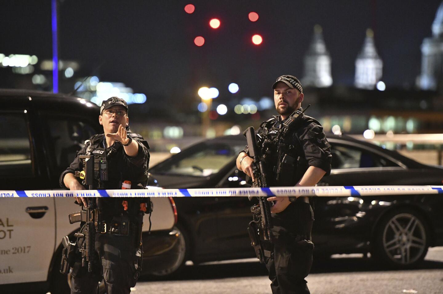 Armed police stand guard on London Bridge after reports of the attack.