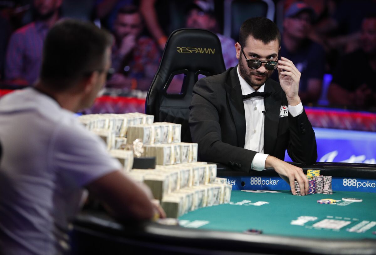 Dario Sammartino, right, of Italy, looks at Hossein Ensan, of Germany, as they play a hand at the final table of the World Series of Poker main event, Tuesday, July 16, 2019, in Las Vegas. (AP Photo/John Locher)
