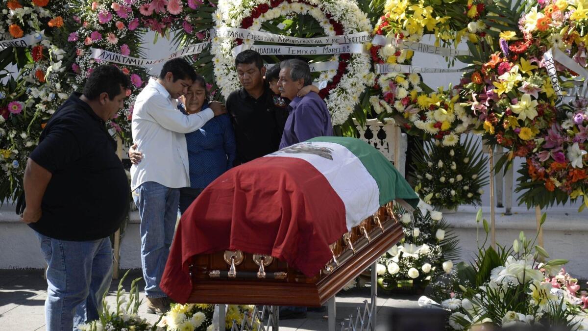 Family members of the slain mayor of Temixco, Mexico, Gisela Mota, mourn next to her casket.