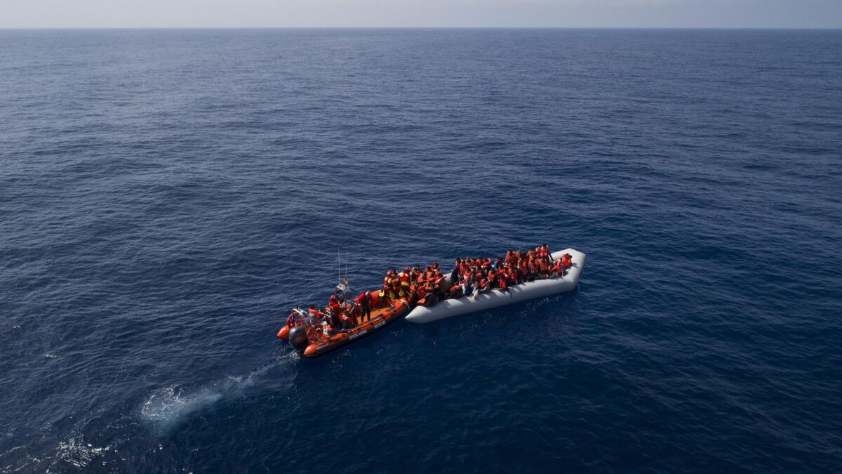 Refugees and migrants are rescued by members of Proactiva Open Arms. The migrants said smugglers removed their boat's engine halfway through the Mediterranean crossing and left them.