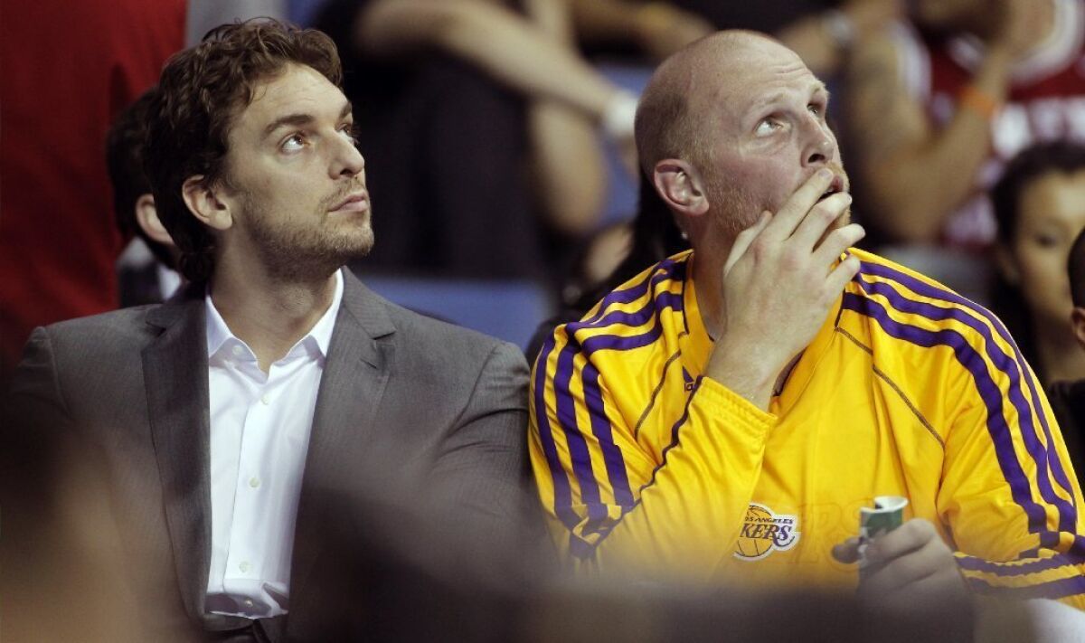 Chris Kaman, right, on the Lakers' bench with Pau Gasol, played for the Clippers for eight seasons.