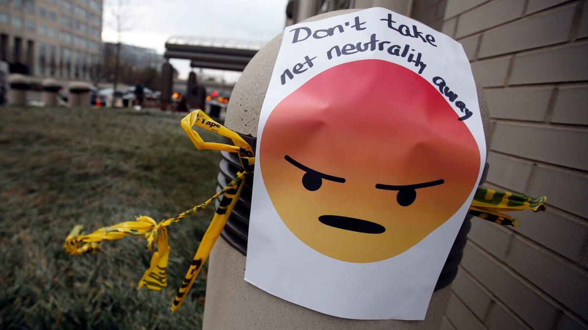 A sign supporting net neutrality is posted outside FCC headquarters in Washington on Dec. 14. The FCC voted that day to eliminate net neutrality regulations for the internet.