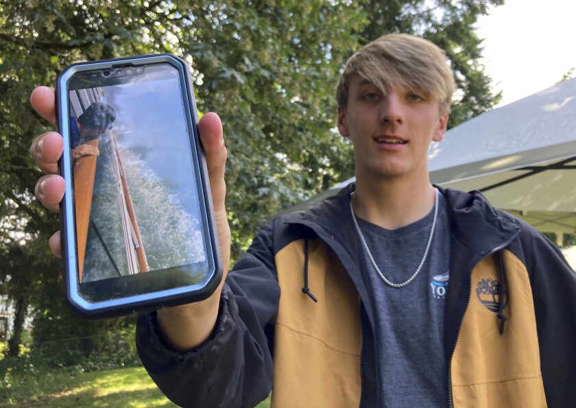 Las Vegas resident Benjamin Talbott poses with his phone at the home of a relative in Renton, Wash., on Thursday, June 30, 2022. Talbott and his family were on the Norwegian Sun when the ship struck an iceberg, forcing it to return to dock for repairs in Seattle. Talbott recorded the collision on his phone and his video garnered millions of views. (AP Photo/Manuel Valdes)