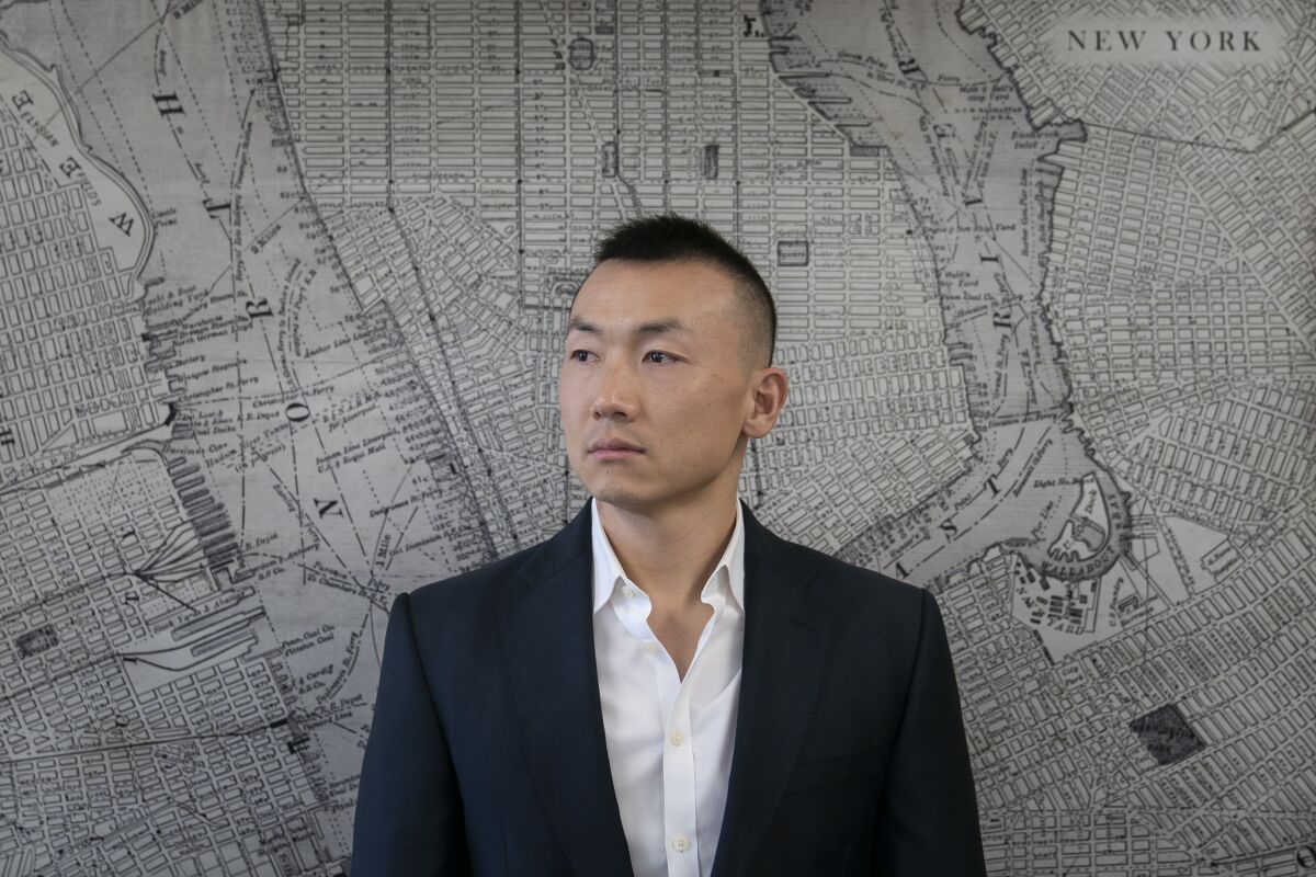 Baimadajie Angwang is photographed at the Law Office of John F. Carman, Esq., before an interview with the Associated Press, Wednesday, Feb. 1, 2023, in Garden City, N.Y. In a few terrifying minutes nearly three years ago, Angwang's life took an abrupt turn — from a teenaged asylum seeker, U.S. Marine and NYPD officer to an accused spy for China. Last month the government dismissed charges against him without fully explaining why. (AP Photo/John Minchillo)