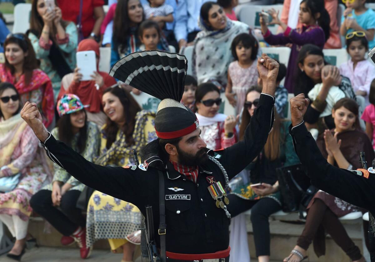 A Pakistani Ranger raises his arms during the flag ceremony at the Indo-Pakistani border post of Wagah.