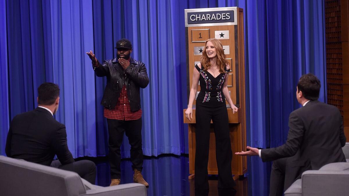 Joe Manganiello (seated, left), Tariq Trotter of the Roots (standing, left), Jessica Chastain, center, and host Jimmy Fallon, seated right, play charades on "The Tonight Show Starring Jimmy Fallon" on March 21, 2017 in New York City.