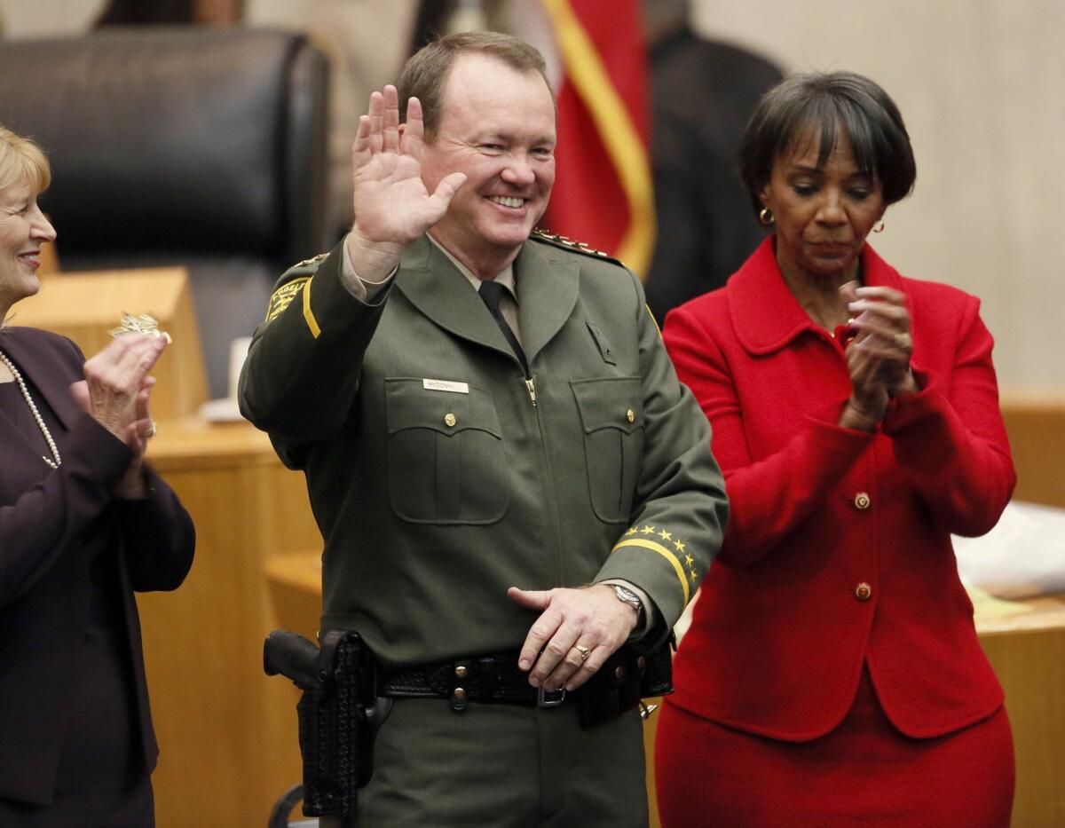 Jim McDonnell, left, is sworn in as the new Los Angeles County Sheriff's by Los Angeles County District Attorney, Jackie Lacey, right, on Dec. 1. He replaces Lee Baca, who retired in January amid a federal investigation of alleged county jail corruption and abuse.
