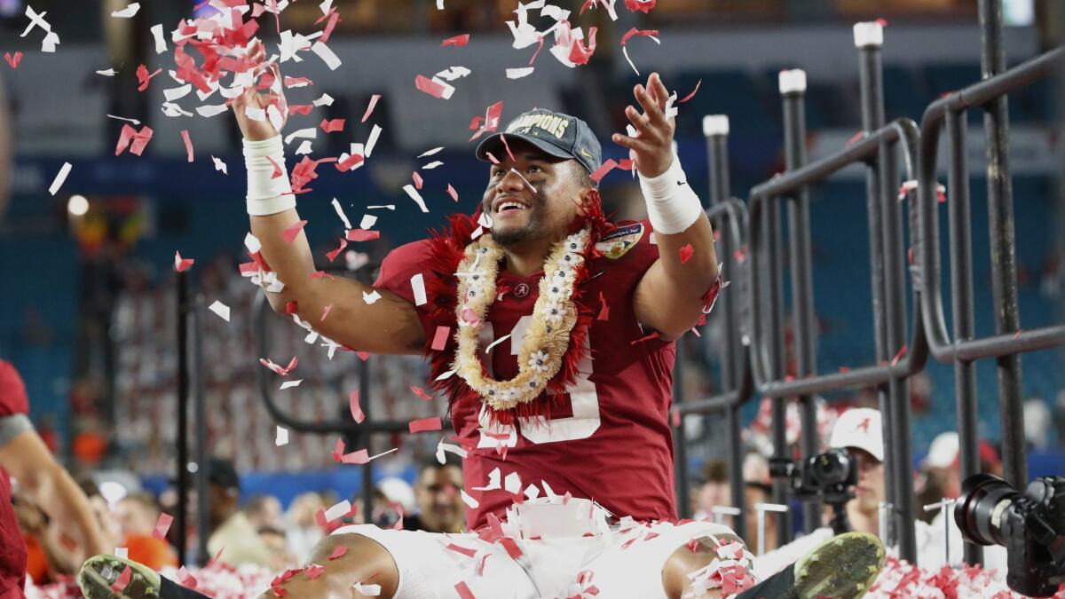 Alabama quarterback Tua Tagovailoa throws confetti into the air after beating Oklahoma to win the Orange Bowl on Dec. 30, 2018.