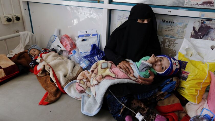 A Yemeni woman holds her sick child as he receives medical attention at a hospital in Sana'a, Yemen on Jan. 12. According to UNICEF, the ongoing conflict in Yemen has left more than 11 million children in need of humanitarian assistance.