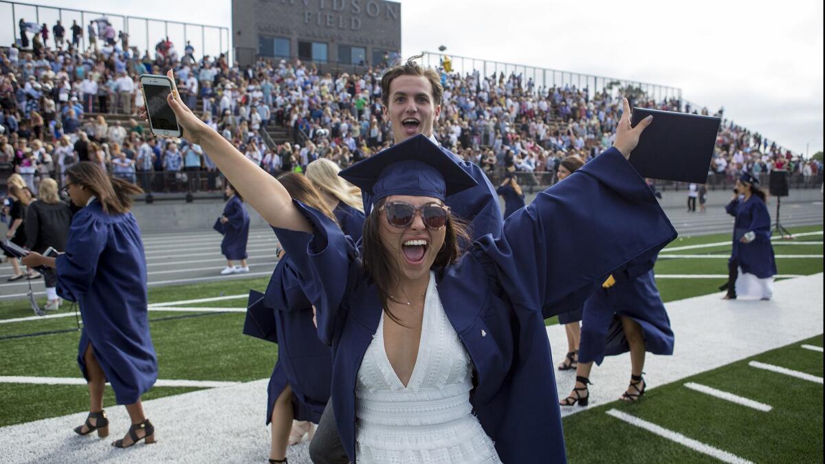 Graduates celebrate as they leave the field following the Newport Harbor High School 2017 commencement at Davidson Field.