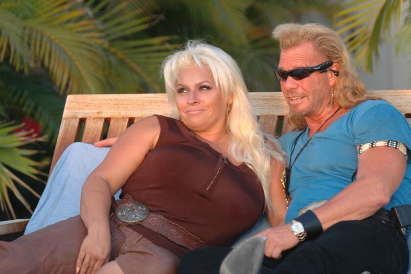 Duane "Dog" Chapman and his wife, Beth, sit in their back yard during a shoot for their A&E network reality show "Dog The Bounty Hunter," Tuesday, Sept. 12, 2006, in Honolulu. Duane Chapman and two co-stars on his show were arrested Thursday, Sept. 14, 2006, in Hawaii on charges of illegal detention and conspiracy in the bounty hunters' capture three years ago of a cosmetics company heir. Chapman, son Leland Chapman and associate Timothy Chapman were taken into custody and did not resist arrest, said Mark Hanohano, U.S. Marshal for the district of Hawaii. (AP Photo/Lucy Pemoni) ORG XMIT: HILP101