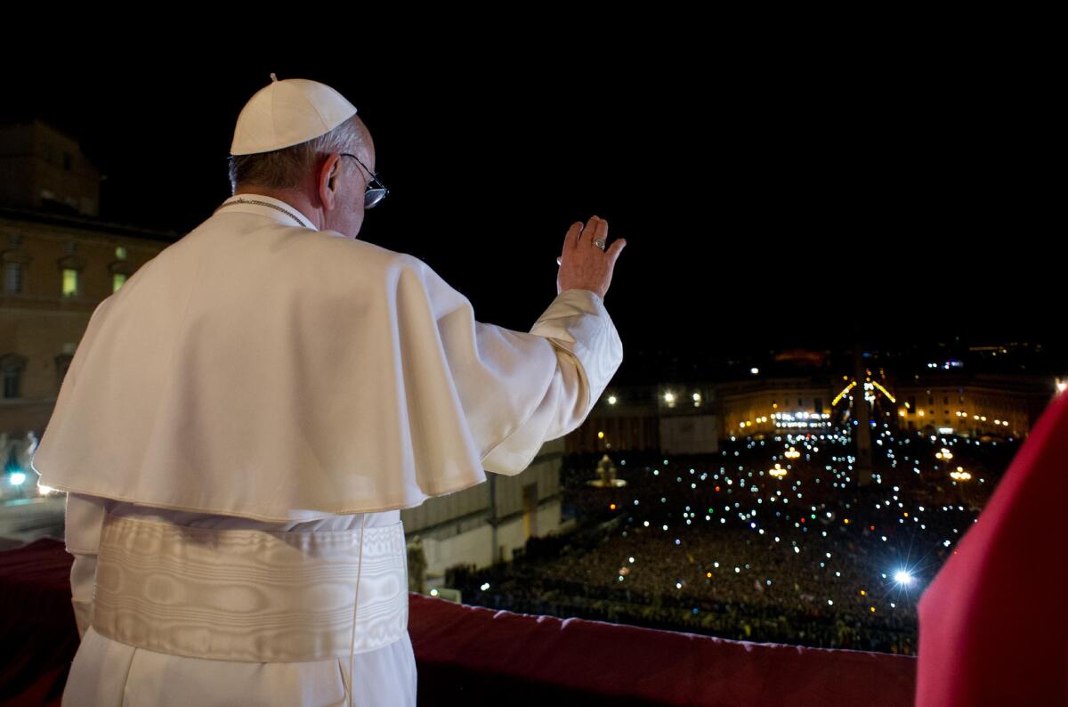 After his election, Pope Francis waves the crowd from the central balcony of St. Peter's Basilica at the Vatican.