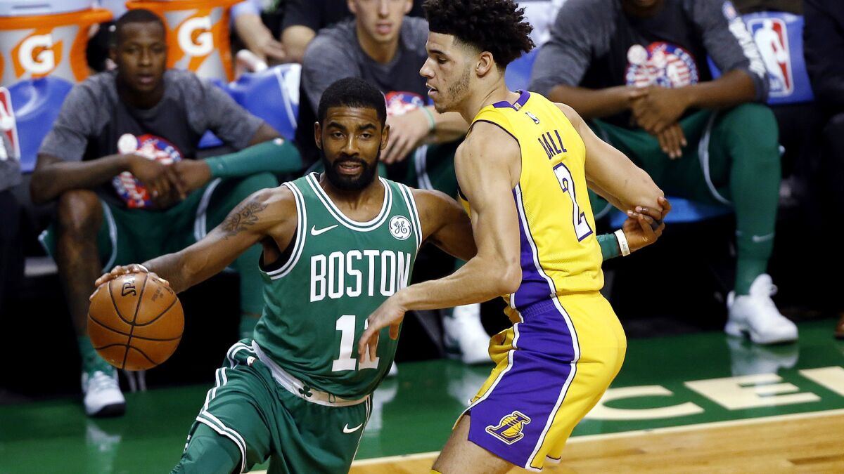 Celtics guard Kyrie Irving drives past Lakers guard Lonzo Ball during the first quarter Wednesday night in Boston
