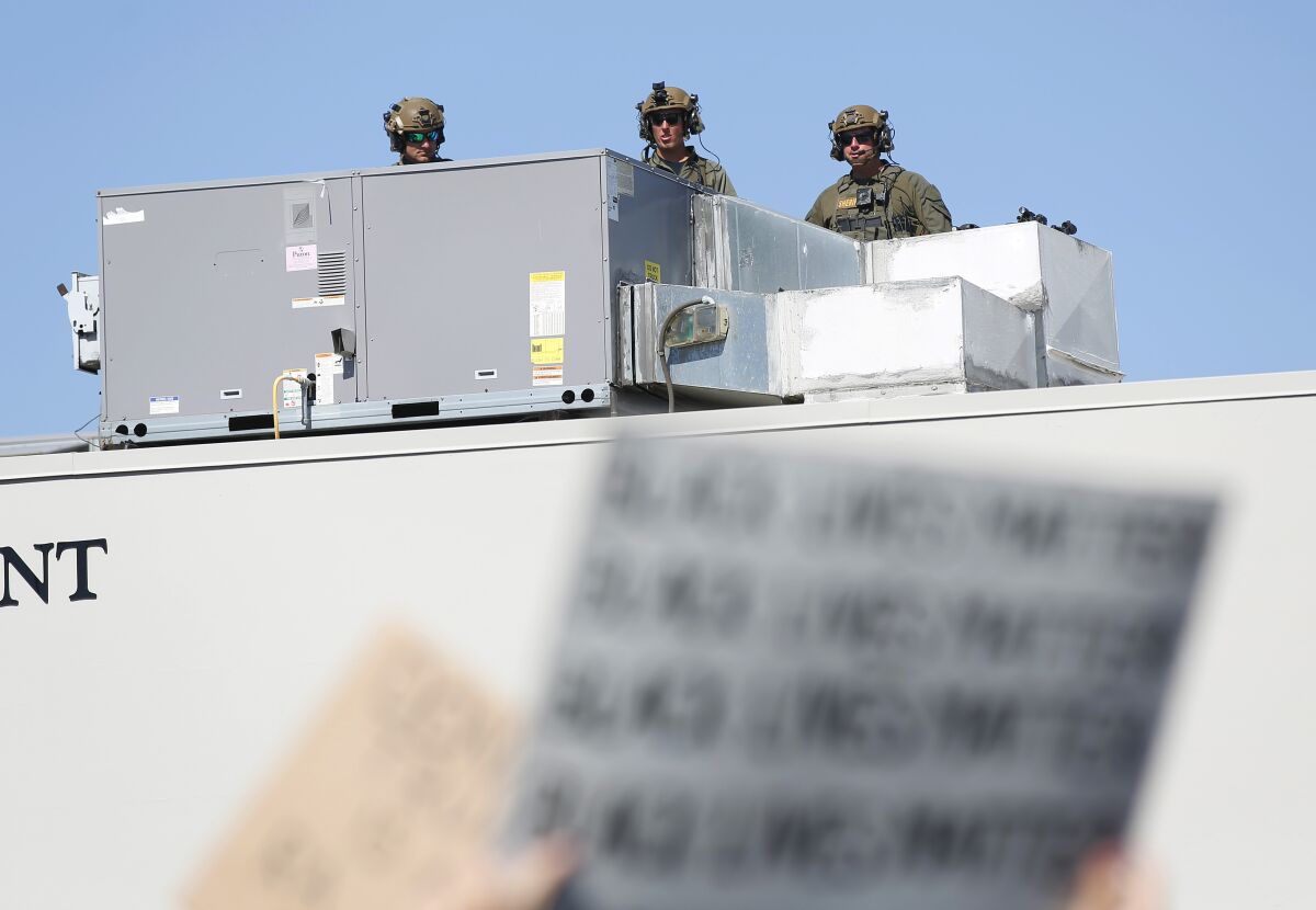 Deputies stand on the roof of Santee substation while Black Lives Matter supporters hold rally on June 7, 2020.
