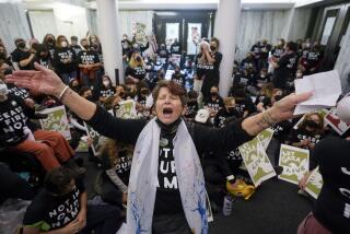 Demonstrators stage a sit-in demanding a cease-fire in the Israel-Hamas war Monday, Nov. 13, 2023, in Oakland, Calif. (AP Photo/Godofredo A. Vásquez)