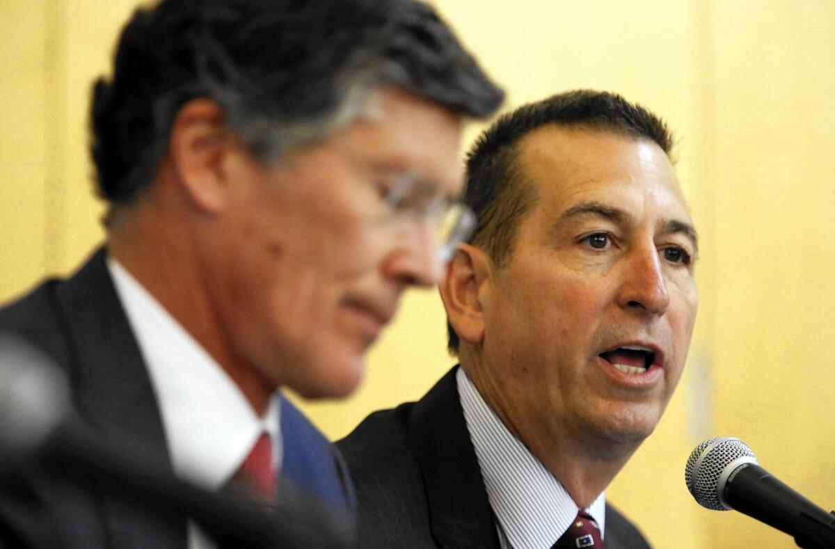 John Thain, left, of CIT and OneWest's Joseph Otting attend a hearing in Los Angeles on the proposed $3.4-billion buyout of OneWest by CIT.