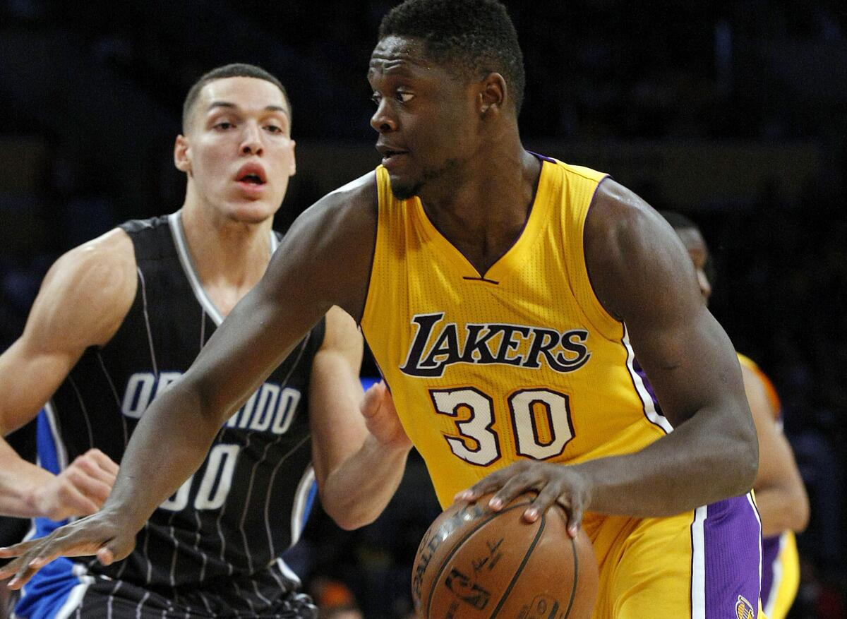 Lakers forward Julius Randle drives to the basket against Magic forward Aaron Gordon during the first quarter of a game on March 8 at Staples Center.