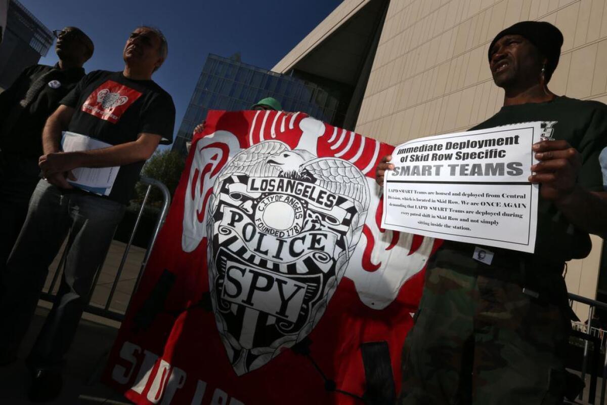 Members of Stop LAPD Spying Coalition and Los Angeles Community Action Network rally outside Los Angeles police headquarters in downtown L.A., demanding an independent investigation into the skid row shooting of a homeless man earlier this month.