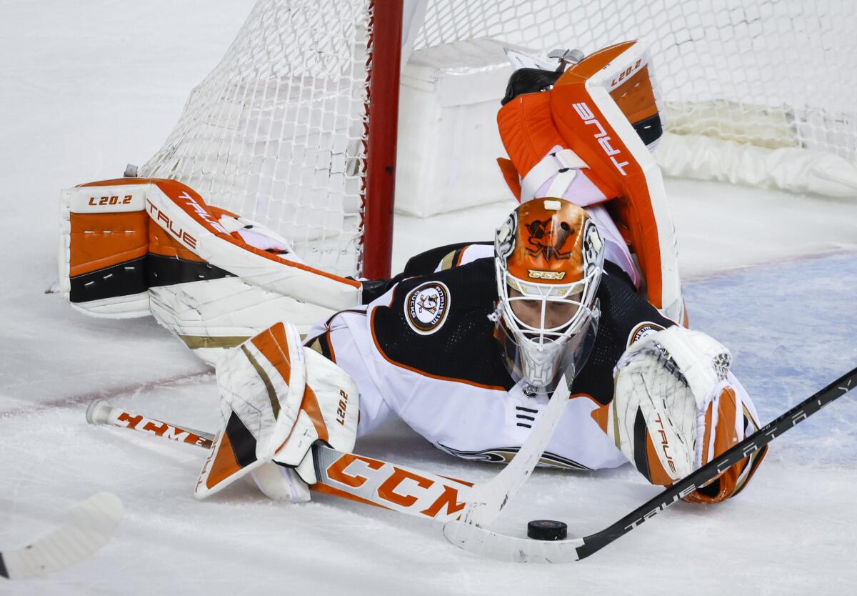 Ducks goalie Lukas Dostal dives for the puck during the third period of a 5-4 loss.