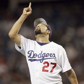 Dodger pitcher Jose Lima looks to the sky after retiring the Colorado Rockies in the third inning Thursday at Dodger Stadium.