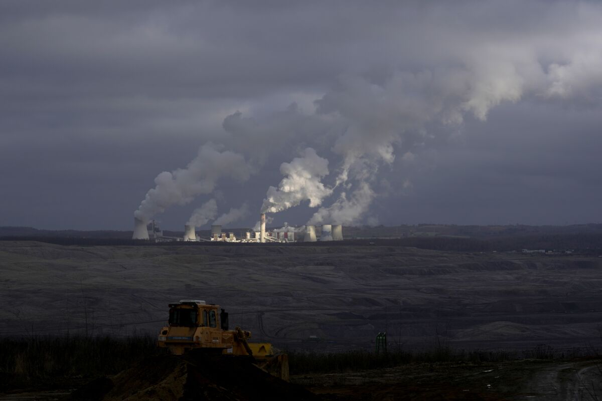 FILE - Smoke rises from chimneys of Turow power plant located by the Turow lignite coal mine near the town of Bogatynia, Poland, Jan. 15, 2022. Poland’s state news agency PAP said Thursday, Feb. 3 its sources say that the government has approved a draft deal with the Czech Republic to end months of stalemate over a Polish lignite mine that Prague says is harmful to the border area environment. (AP Photo/Petr David Josek, file)